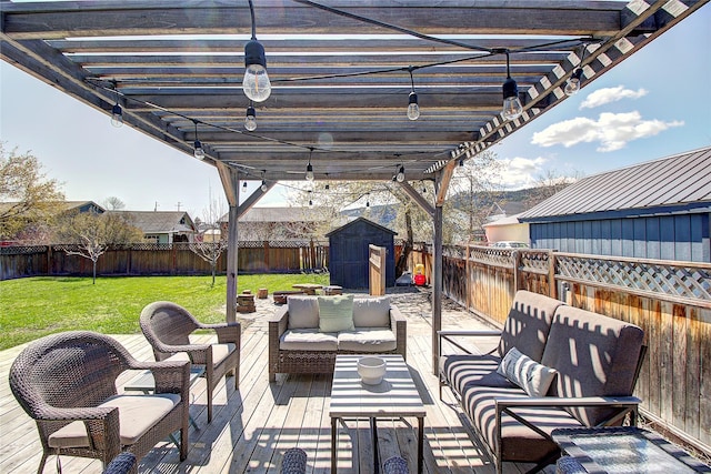 view of patio / terrace with an outdoor living space, a fenced backyard, and a shed