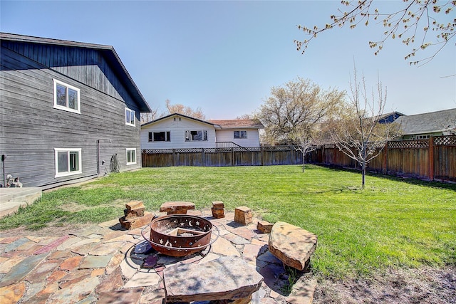 view of yard with a patio, a fenced backyard, and an outdoor fire pit