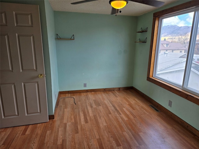 1512 Gaylord St, Butte, MT 59701 - empty room with visible vents, a ceiling fan, light wood finished floors, and baseboards