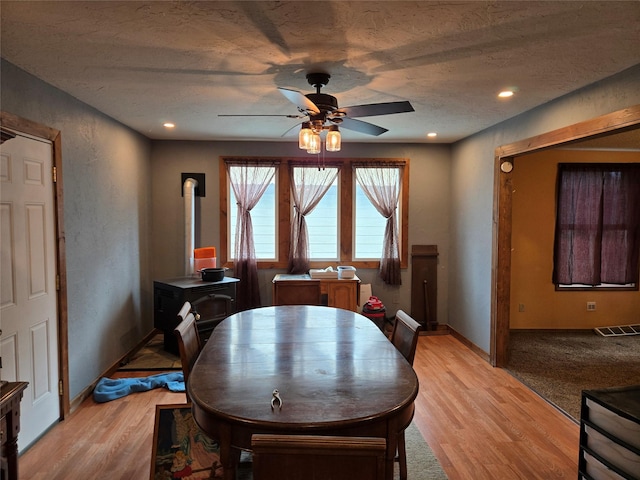 1512 Gaylord St, Butte, MT 59701 - dining space with a wood stove, recessed lighting, light wood-style floors, ceiling fan, and visible vents