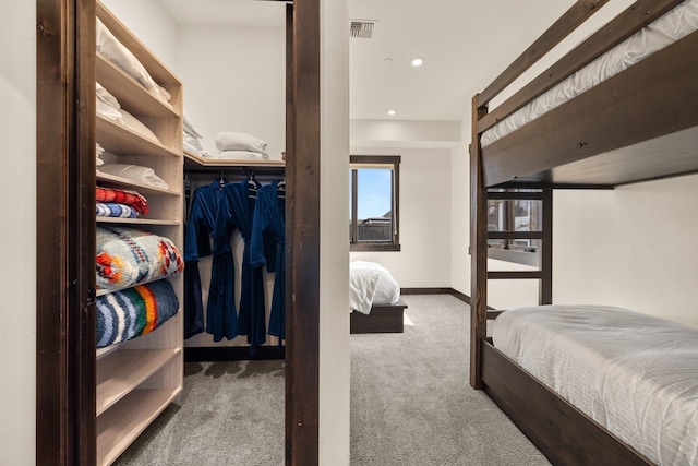 carpeted bedroom featuring baseboards, visible vents, and recessed lighting