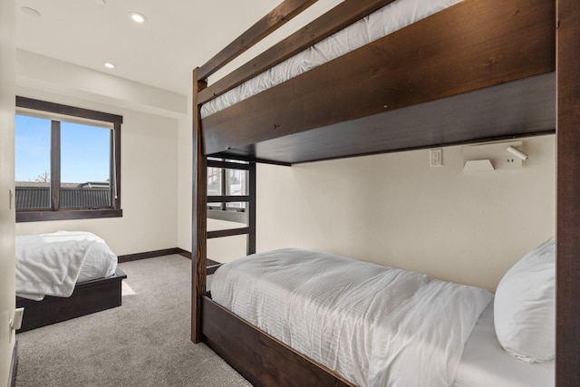 carpeted bedroom featuring baseboards, recessed lighting, and multiple windows