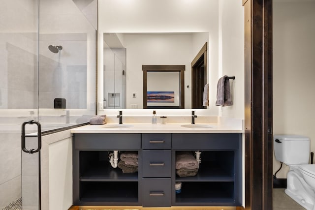 bathroom with a stall shower, toilet, and a sink
