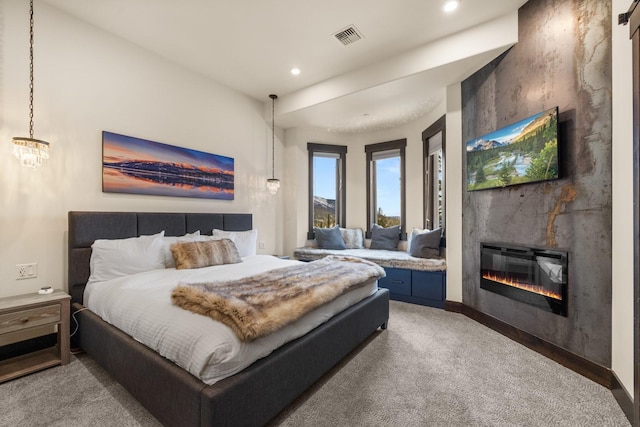 bedroom with a large fireplace, visible vents, recessed lighting, and carpet