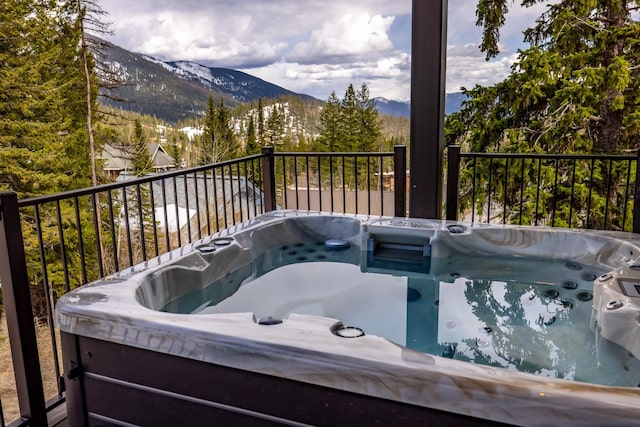 wooden terrace with a mountain view and a hot tub