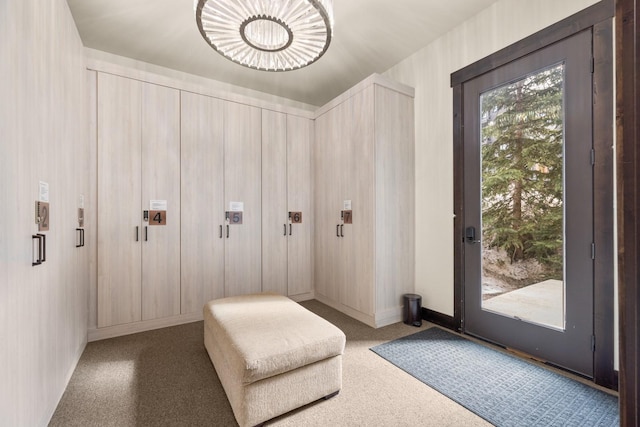 interior space with carpet and baseboards