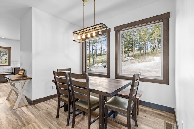 270 Westridge Dr, Somers, MT 59932 - dining room with visible vents, a chandelier, wood finished floors, and baseboards