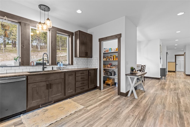 270 Westridge Dr, Somers, MT 59932 - kitchen with a wealth of natural light, dark brown cabinets, stainless steel dishwasher, and a sink