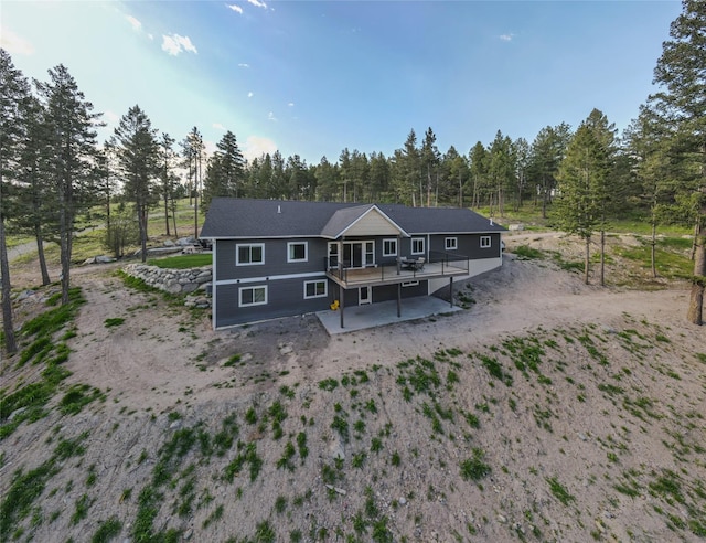 270 Westridge Dr, Somers, MT 59932 - rear view of property featuring a wooden deck, driveway, and a patio area