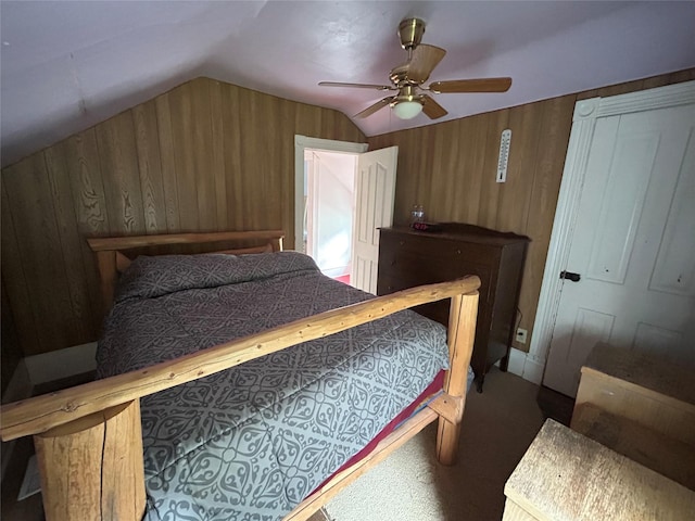 bedroom with ceiling fan, wood walls, lofted ceiling, and carpet floors