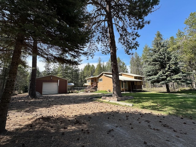 view of yard with an outdoor structure and a garage