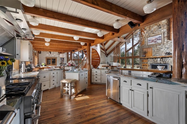 kitchen with dark wood-style flooring, lofted ceiling with beams, a peninsula, white cabinets, and appliances with stainless steel finishes