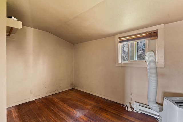 additional living space featuring baseboards, wood-type flooring, and vaulted ceiling