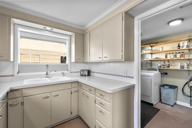 washroom with light carpet, washer / clothes dryer, laundry area, and a sink