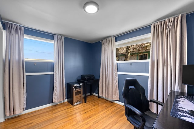 home office featuring wood finished floors and baseboards