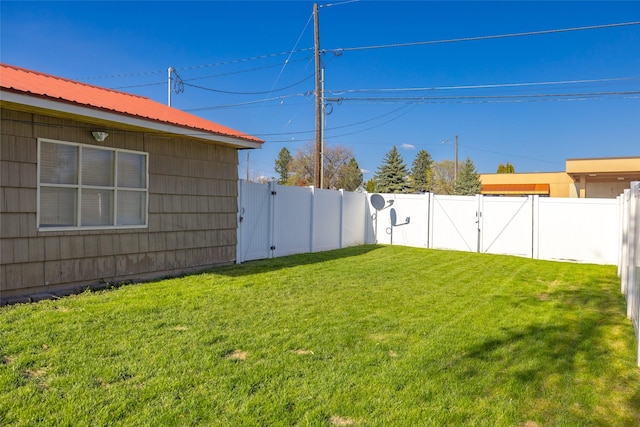 view of yard with a gate and a fenced backyard