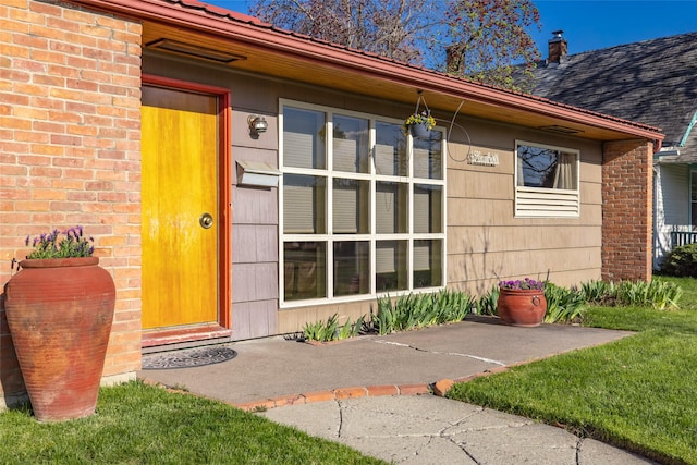 entrance to property featuring brick siding