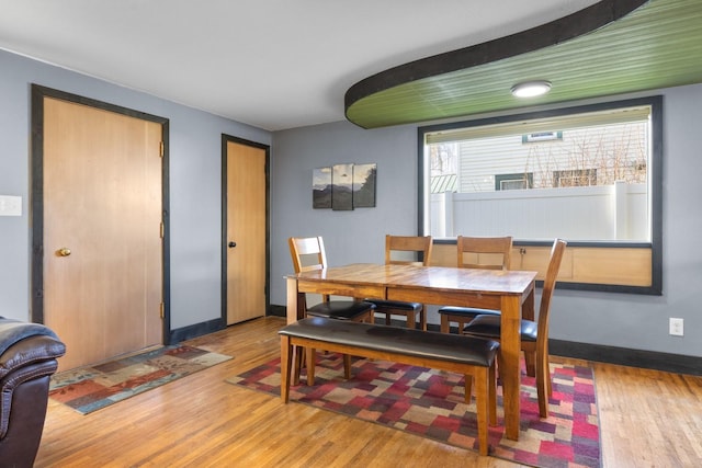 dining area featuring baseboards and wood finished floors