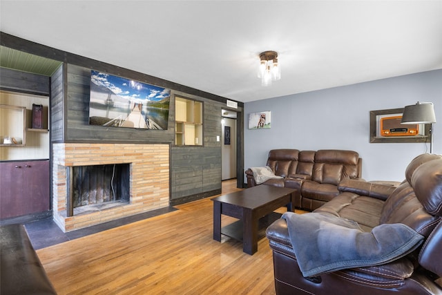living area with wood finished floors and a fireplace