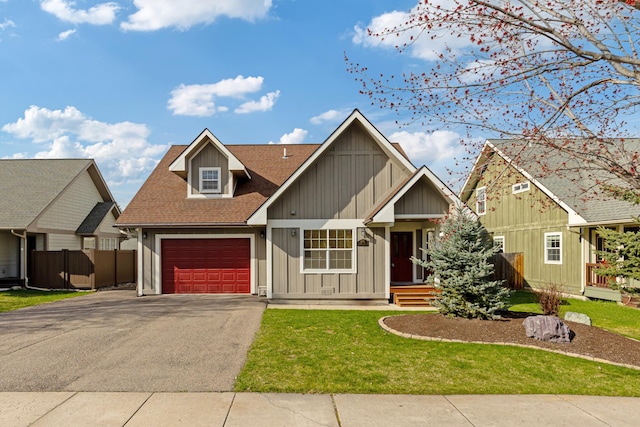 craftsman inspired home with board and batten siding, fence, a shingled roof, driveway, and an attached garage