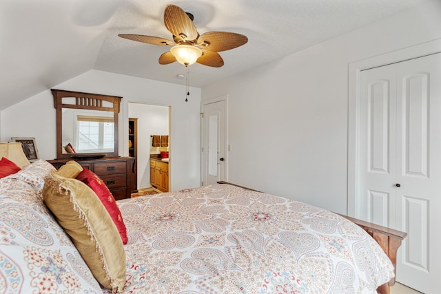 bedroom with a ceiling fan, a closet, vaulted ceiling, and ensuite bathroom