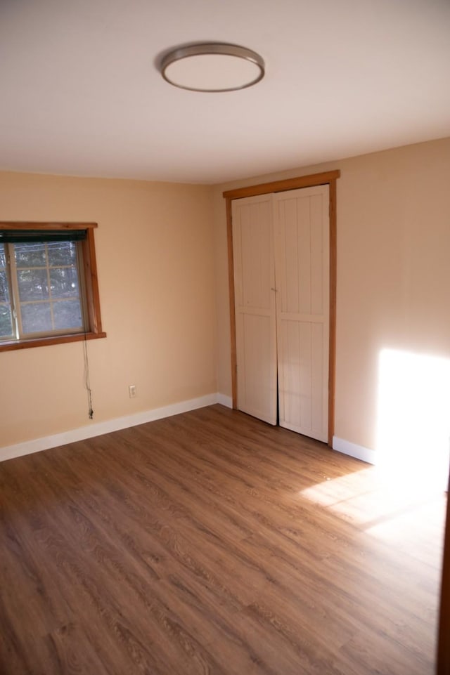 unfurnished bedroom featuring baseboards and wood finished floors