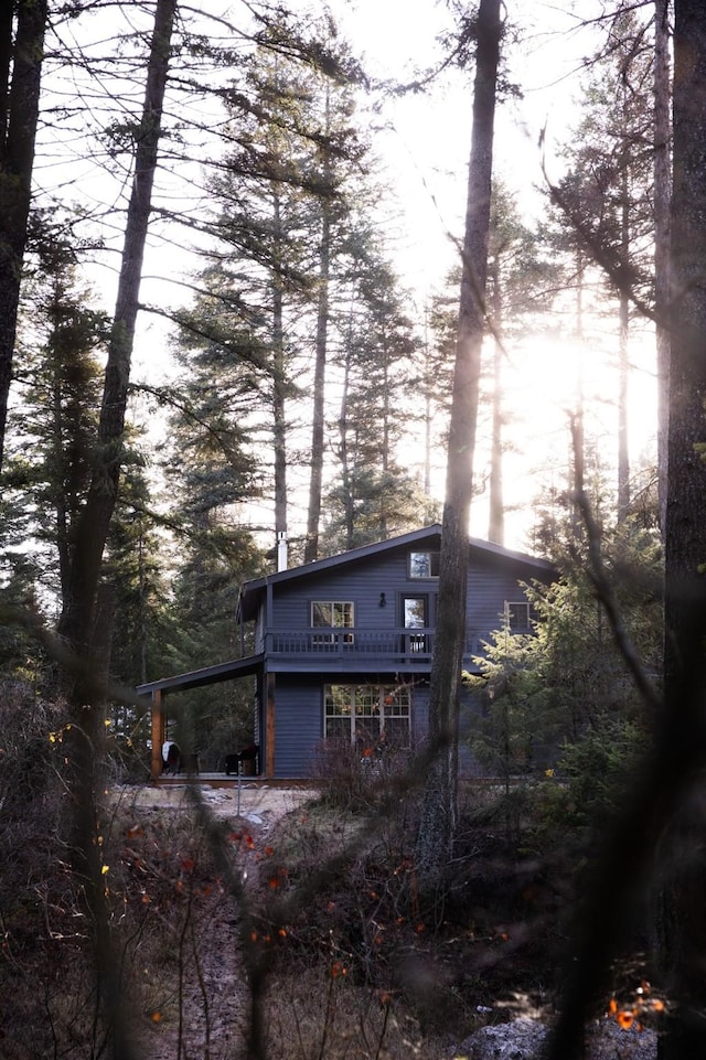 rear view of property featuring a deck