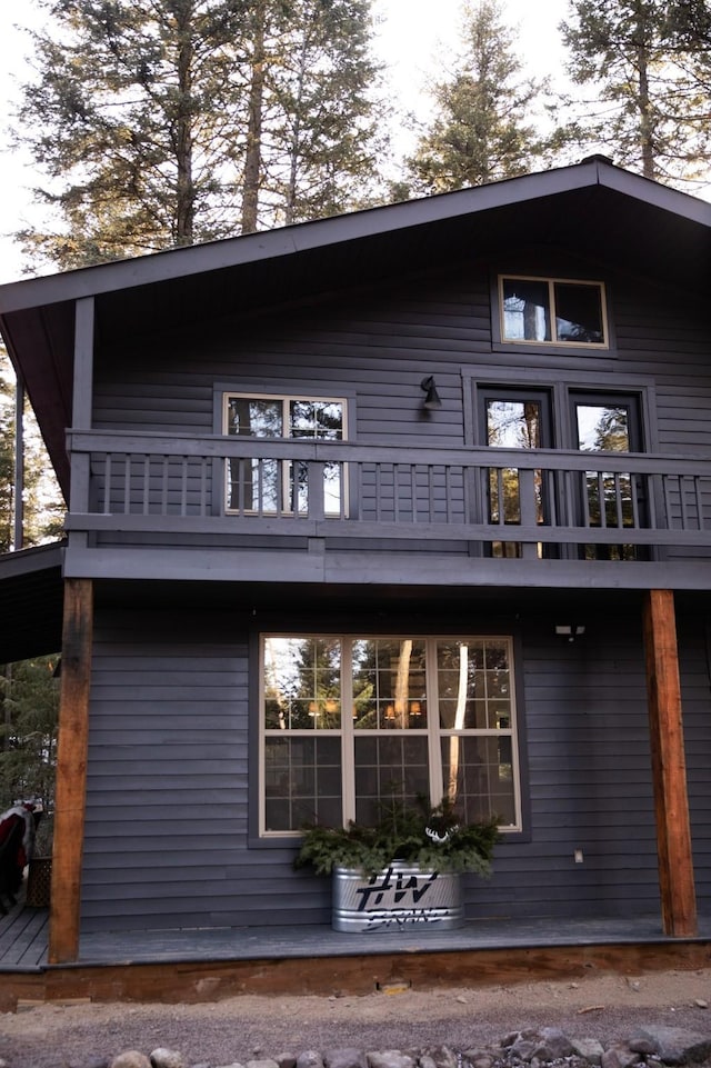 rear view of property featuring a balcony