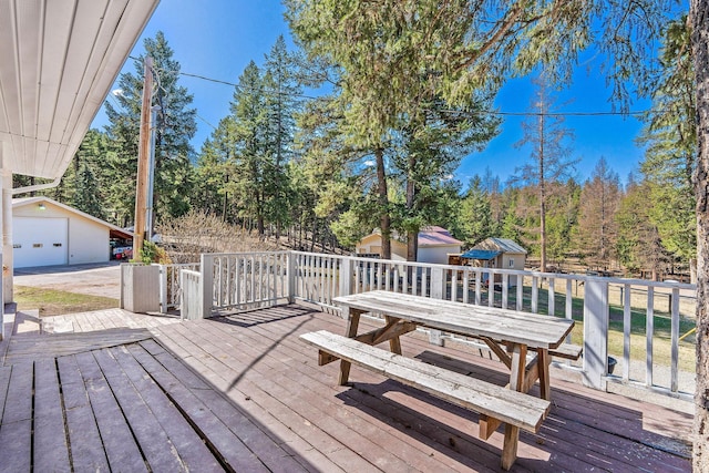 deck with an outdoor structure and a garage