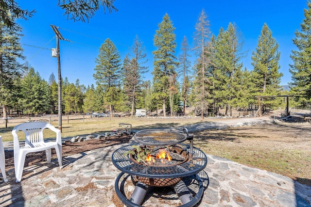 view of patio with a fire pit and fence