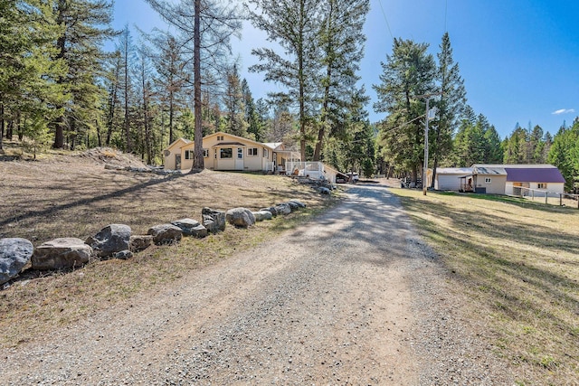 view of street with dirt driveway