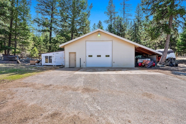 garage featuring driveway and a detached garage