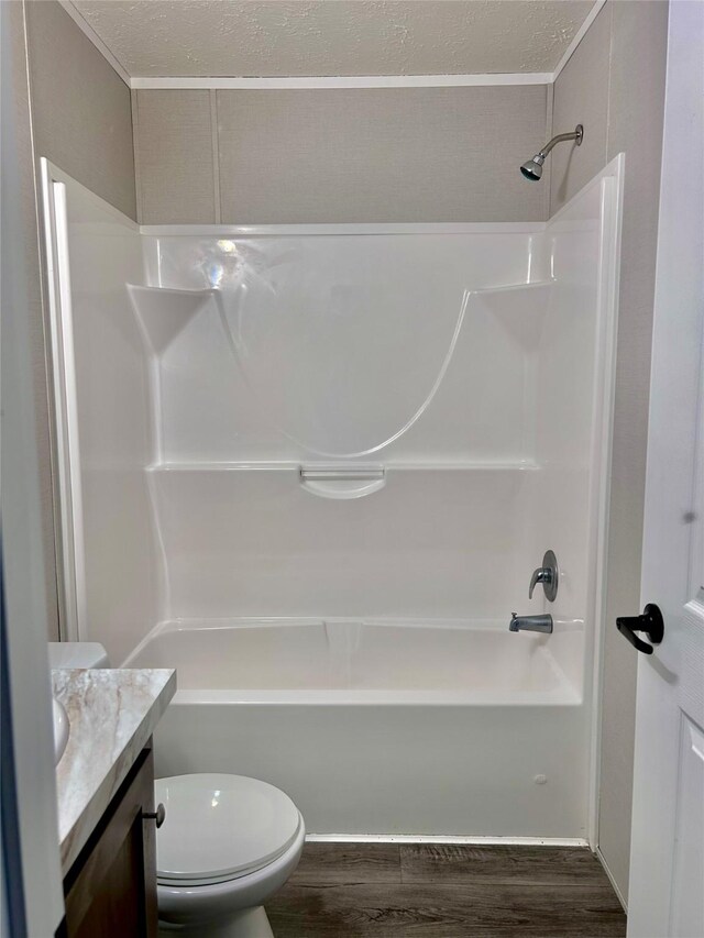 full bath featuring toilet, vanity, shower / bath combination, and wood finished floors