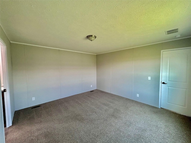 empty room with visible vents, carpet floors, a textured ceiling, and crown molding