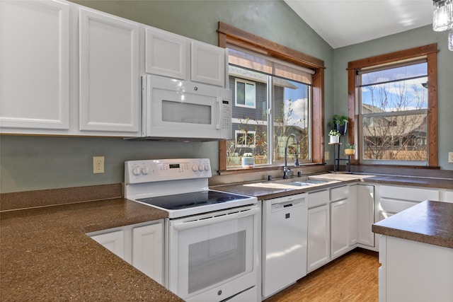 3383 Sora Way, Bozeman, MT 59718 - kitchen with white appliances, dark countertops, white cabinets, and vaulted ceiling