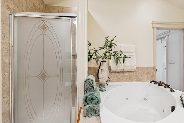 full bathroom with a jetted tub and a shower stall
