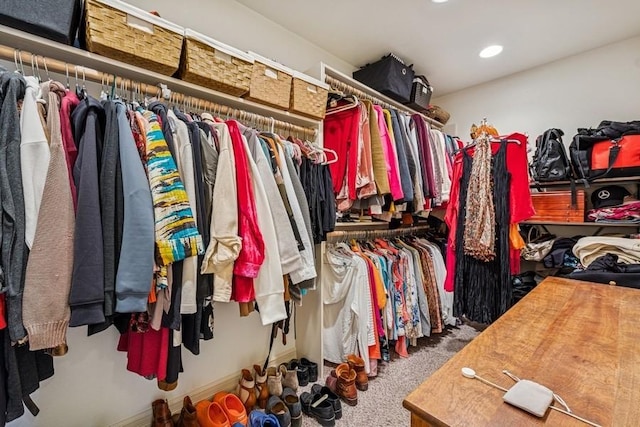 walk in closet featuring carpet flooring