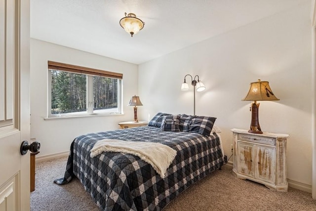 carpeted bedroom featuring baseboards