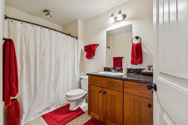 bathroom featuring tile patterned floors, vanity, and toilet