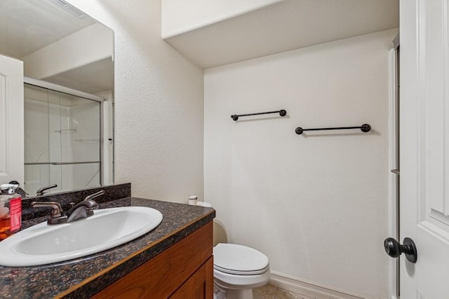 full bath featuring a stall shower, toilet, and vanity