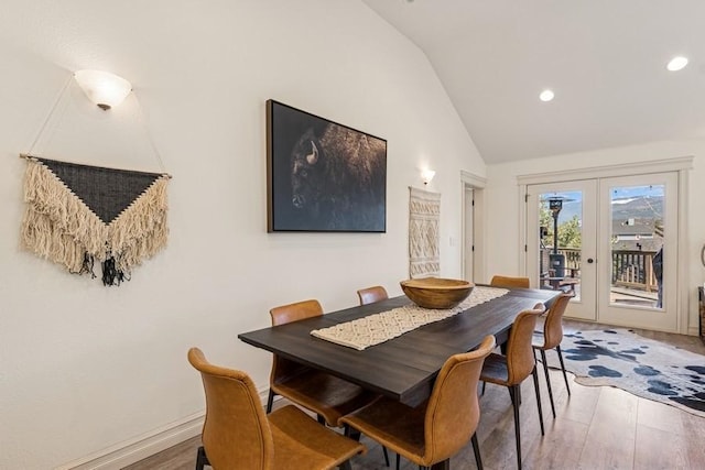 dining room featuring recessed lighting, french doors, high vaulted ceiling, and wood finished floors