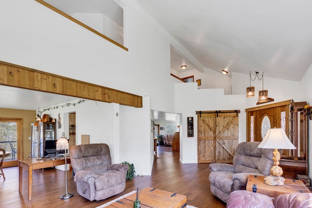 390 Dairy Ln, Superior, MT 59872 - living room with wood finished floors, high vaulted ceiling, a barn door, beamed ceiling, and baseboards