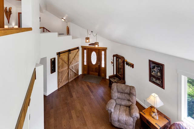 390 Dairy Ln, Superior, MT 59872 - entrance foyer featuring wood finished floors, lofted ceiling, a barn door, and stairway