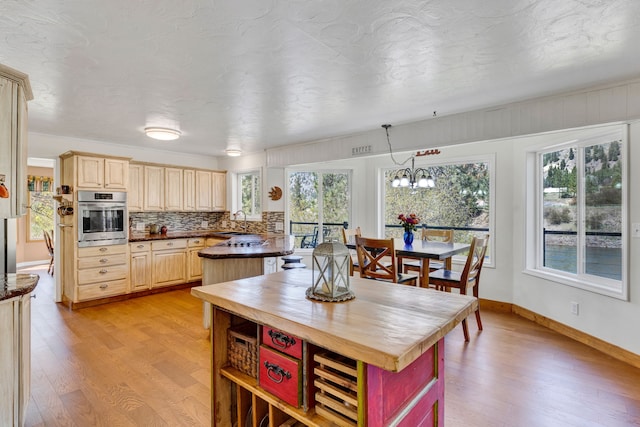 390 Dairy Ln, Superior, MT 59872 - kitchen with oven, light wood-style floors, and light brown cabinets