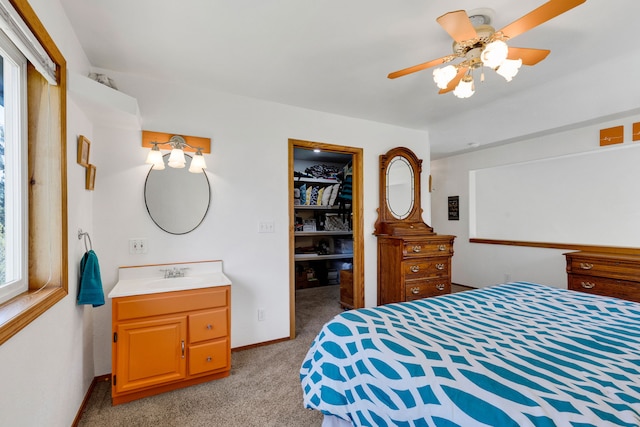 390 Dairy Ln, Superior, MT 59872 - carpeted bedroom featuring a sink, a closet, a spacious closet, and ceiling fan