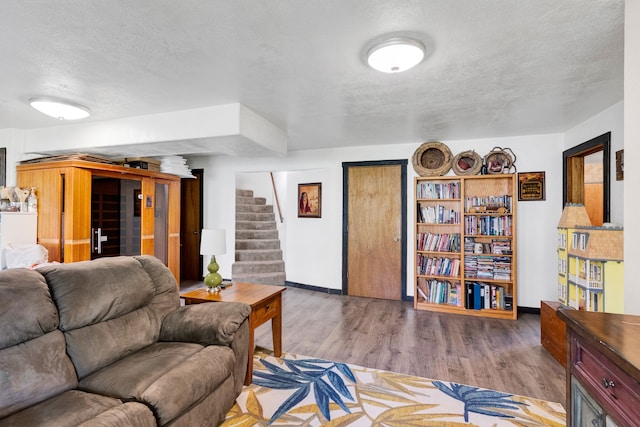 390 Dairy Ln, Superior, MT 59872 - living area with a textured ceiling, wood finished floors, stairs, and baseboards