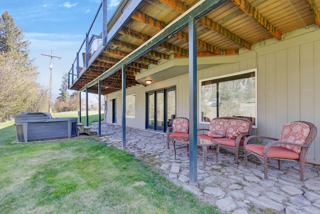 390 Dairy Ln, Superior, MT 59872 - back of house with a hot tub, a patio area, and a lawn