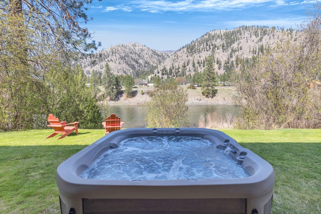 390 Dairy Ln, Superior, MT 59872 - view of grassy yard with a hot tub and a water and mountain view