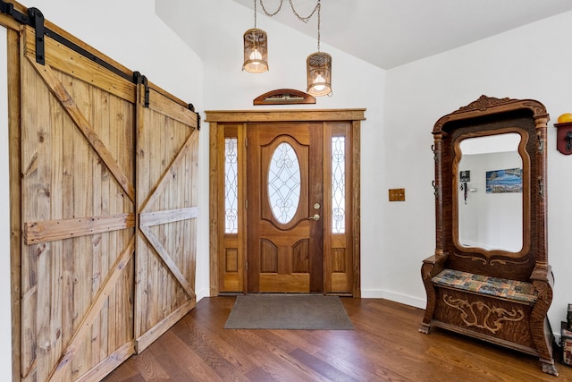 390 Dairy Ln, Superior, MT 59872 - foyer entrance with dark wood-style flooring, baseboards, a barn door, and high vaulted ceiling