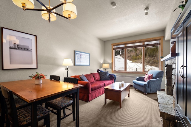 living room featuring carpet flooring, a chandelier, a fireplace, radiator heating unit, and a textured ceiling